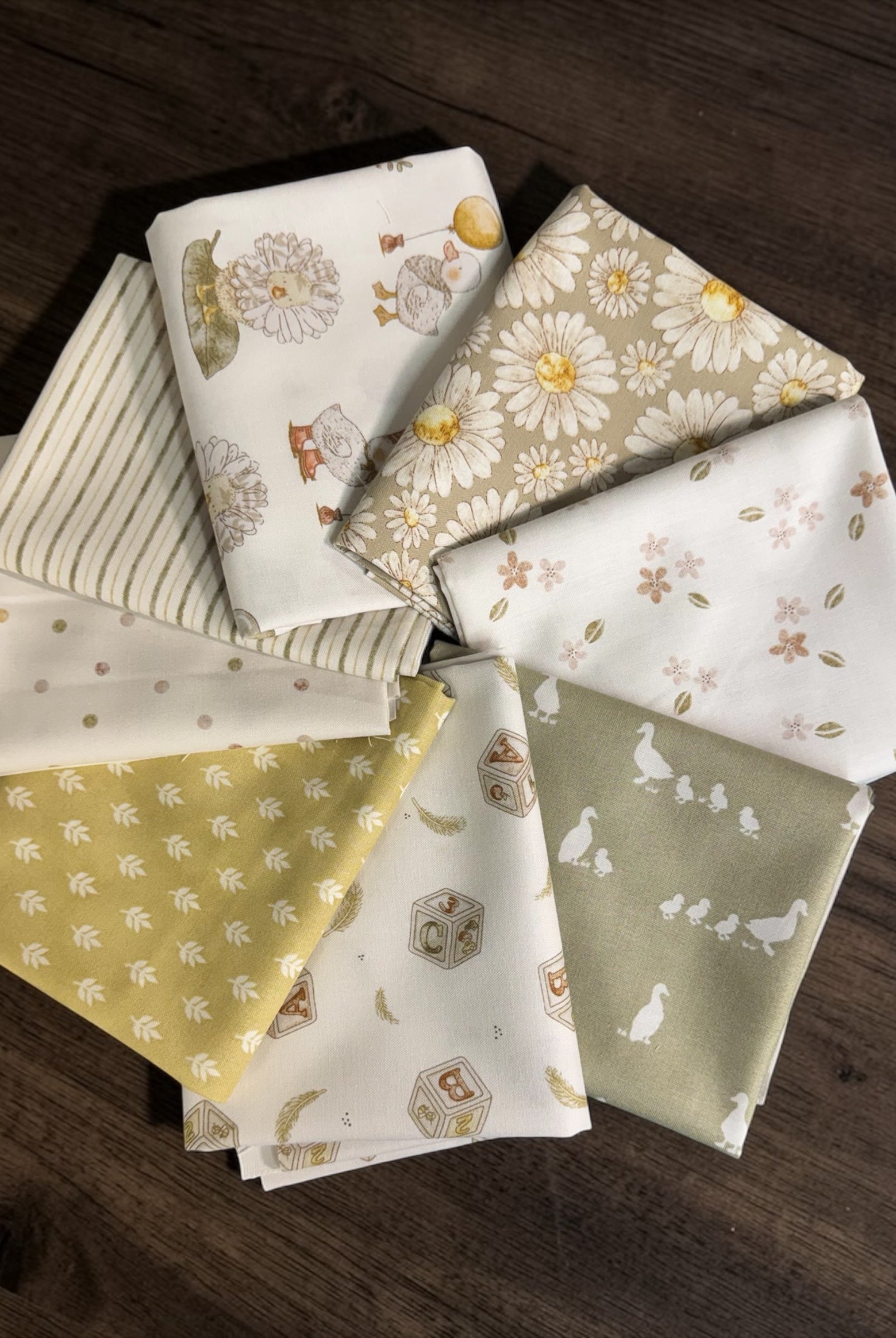 Collection of patterned fabric squares on a wooden surface