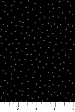 Black fabric with white polka dots and a ruler at the bottom