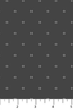 Fabric with a pattern of small white crosses on a dark gray background, with a ruler at the bottom.