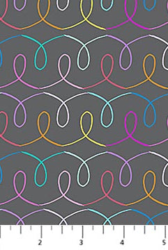 Colorful wavy line pattern on gray fabric with a ruler at the bottom.