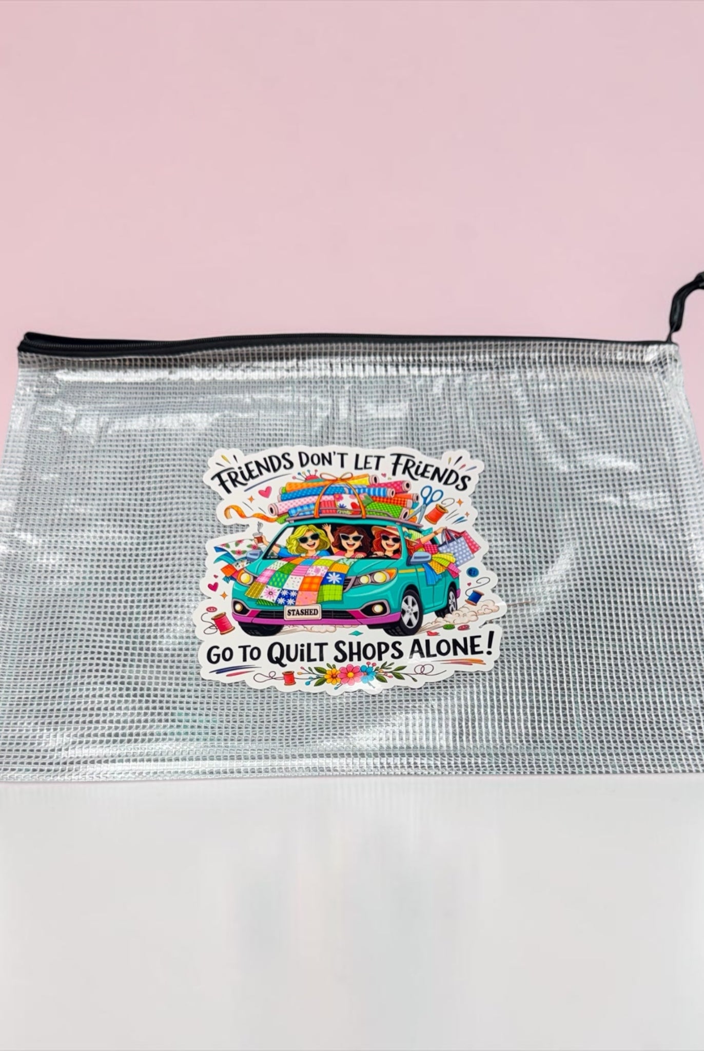 Clear pouch with colorful graphic and text on a pink background