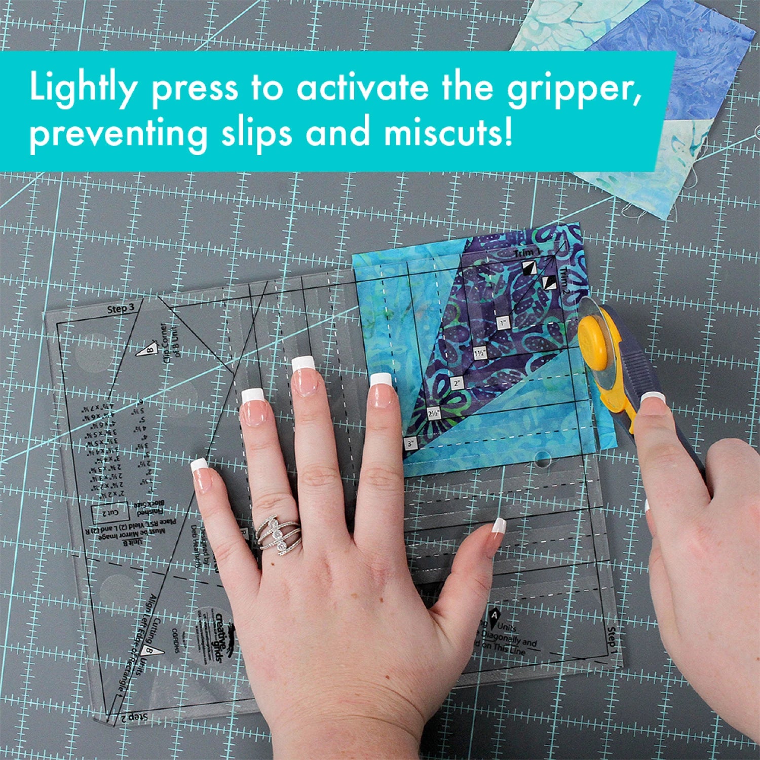 Person cutting fabric with scissors on a cutting mat, text overlay about activating a gripper. Creative Grids Quilt Ruler Kitty Cornered # CGRDH5 - Carmon's Quilt Shop
