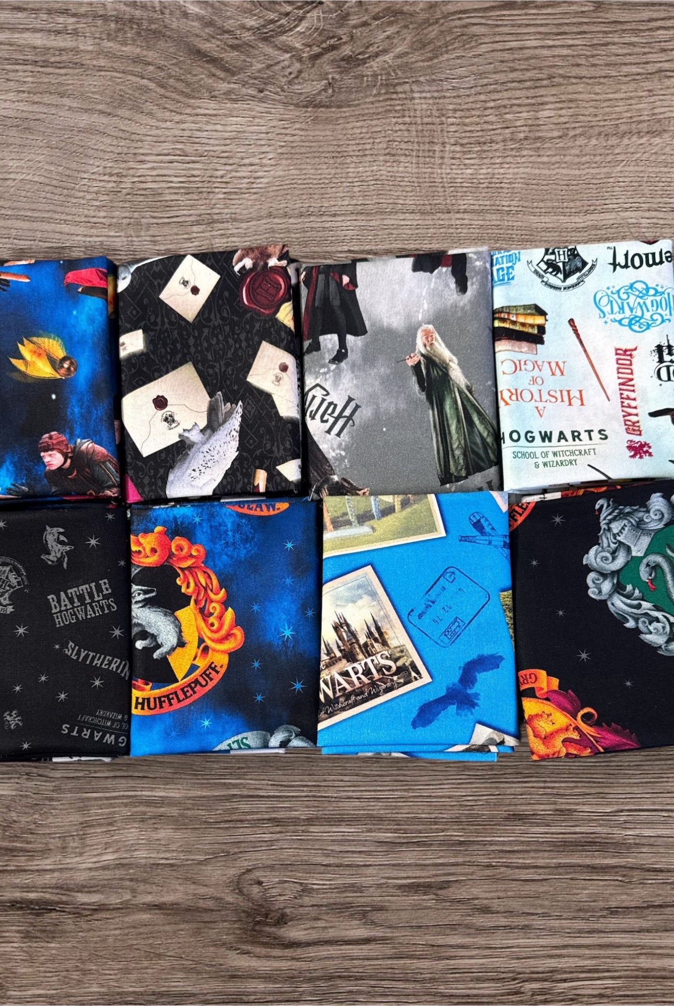 Collection of themed fabric swatches on a wooden surface