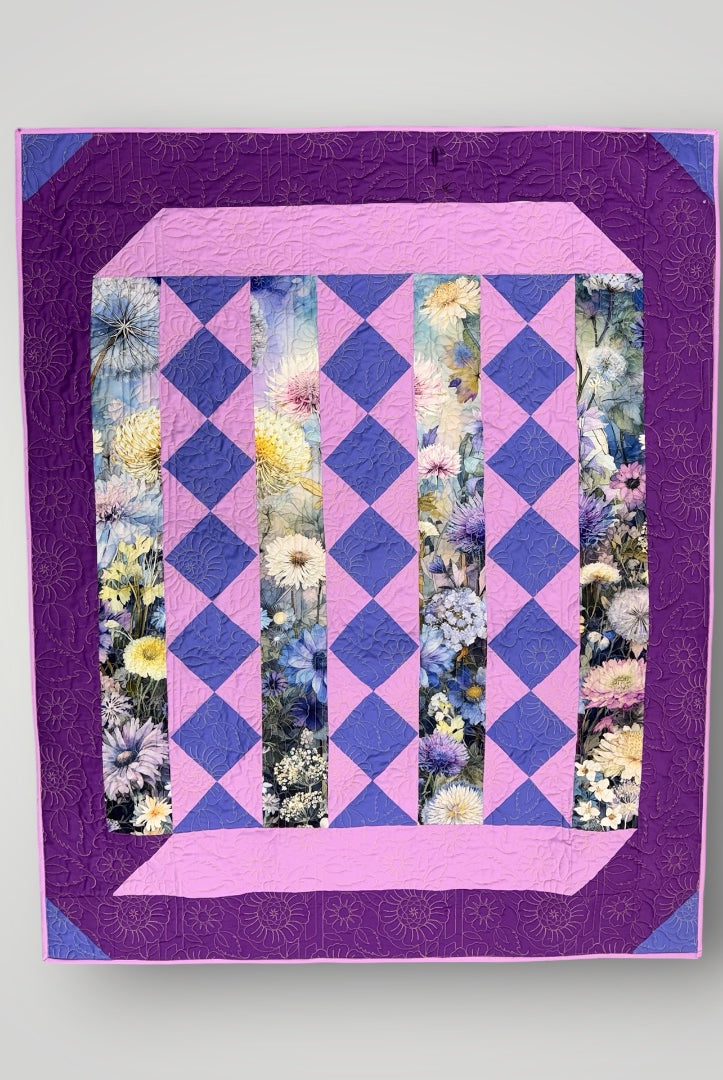 Quilt with purple and pink diamond pattern and floral inserts on a light gray background Lovely Flowers Quilt Kit Finished Size - Northcott/Timeless Treasures Fabric 49.75" x 60" -Carmons Quilt Shop 2