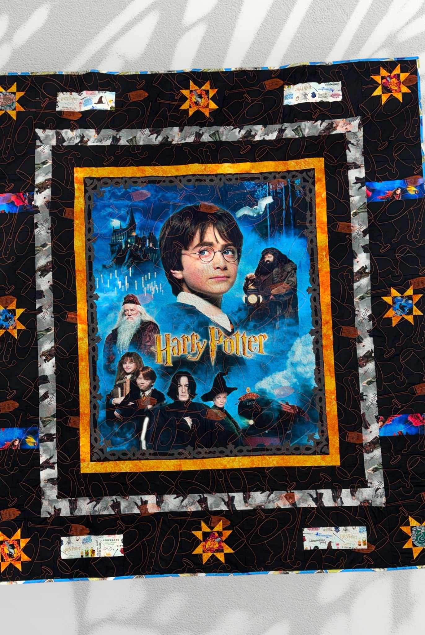 Harry Potter-themed quilt with characters and scenes from the series on a white background
