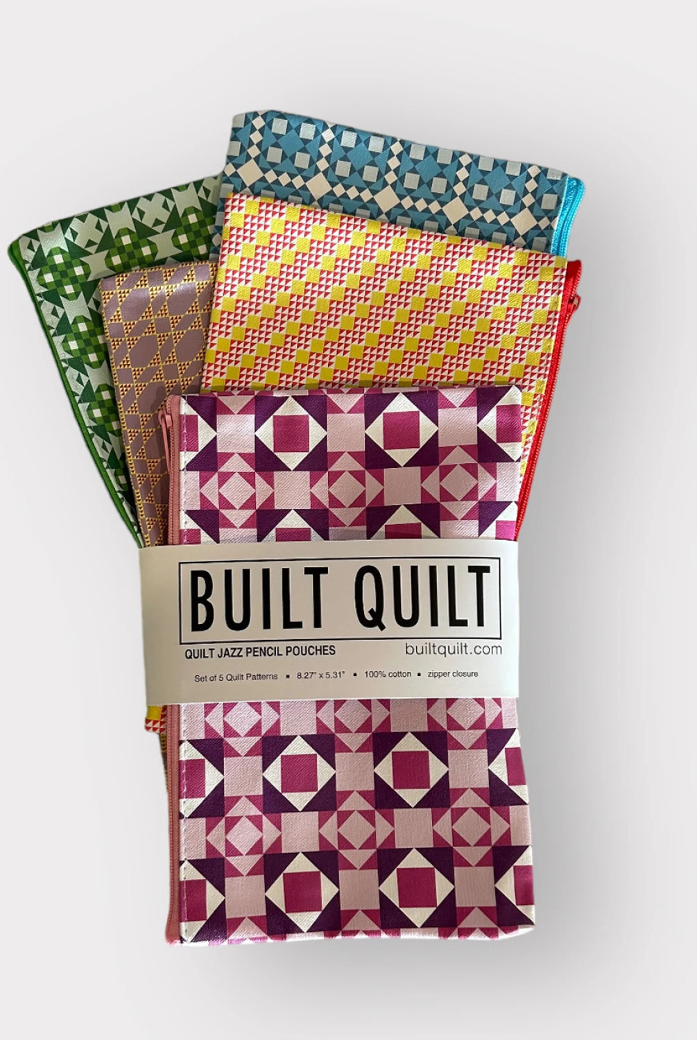Packaged quilt-style pencil pouches with colorful patterns on a white background