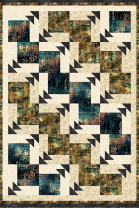 Geometric quilt with black, blue, and brown patterns on a beige background