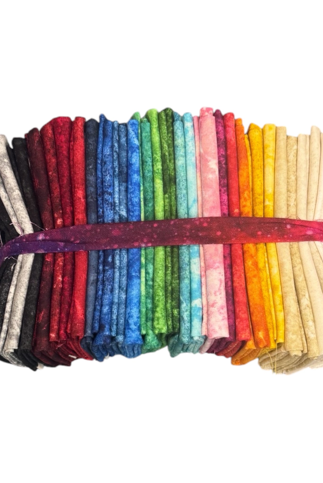 Set of colorful fabric strips tied together on a white background Stonehenge Basics 28 Fat Quarter Bundle Northcott Carmon's Quilt Shop