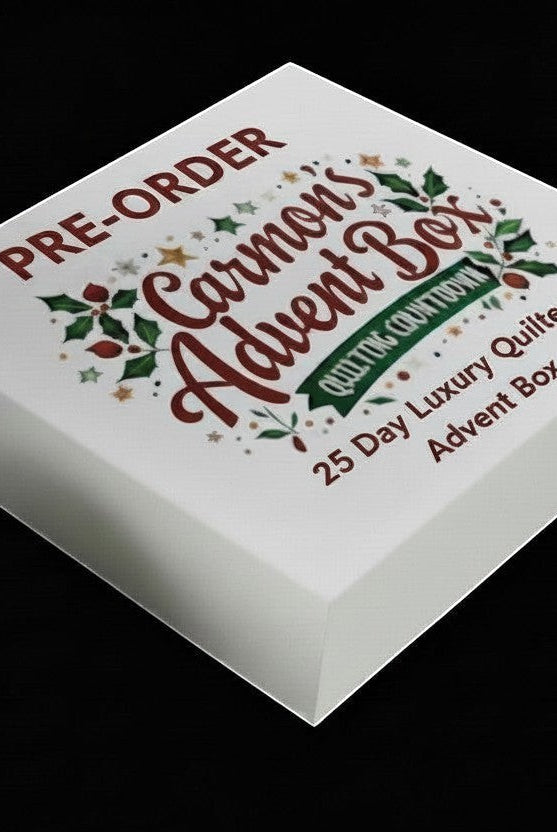 Carmon's Quilt Shop limited-edition 25-day premium quilter's advent box with festive holiday branding on a white box.