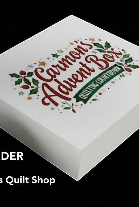 Carmon's Quilt Shop limited-edition premium quilter's advent box with festive holiday branding on a white gift box.
