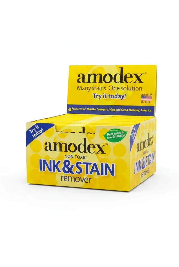 Carmon's Quilt Shop Amodex ink and stain remover trial pack in a yellow display box for fabrics and surfaces