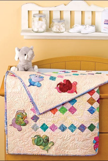 Carmon's Quilt Shop baby quilt featuring colorful elephant appliques and diamond patchwork on a cream background