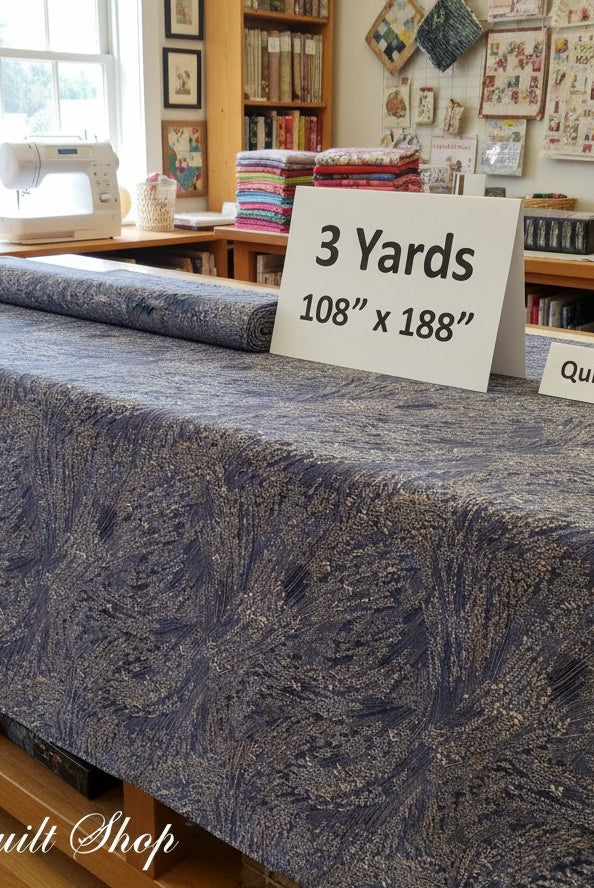 Carmon's Quilt Shop Meadow Breeze brown floral 108-inch wide cotton quilt backing fabric on a cutting table