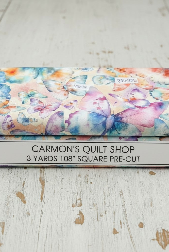 Carmon's Quilt Shop Butterfly Wishes cream cotton fabric 108-inch wide quilt backing with colorful butterfly print.