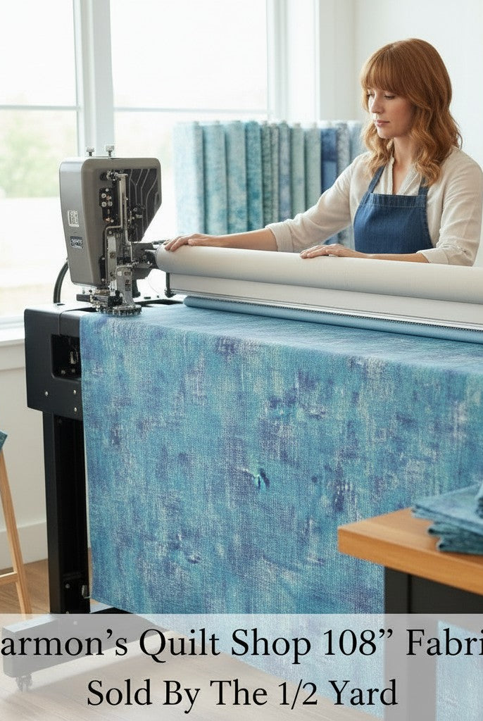 Carmon's Quilt Shop 108 inch denim blue mottled cotton blender fabric being used on a longarm quilting machine