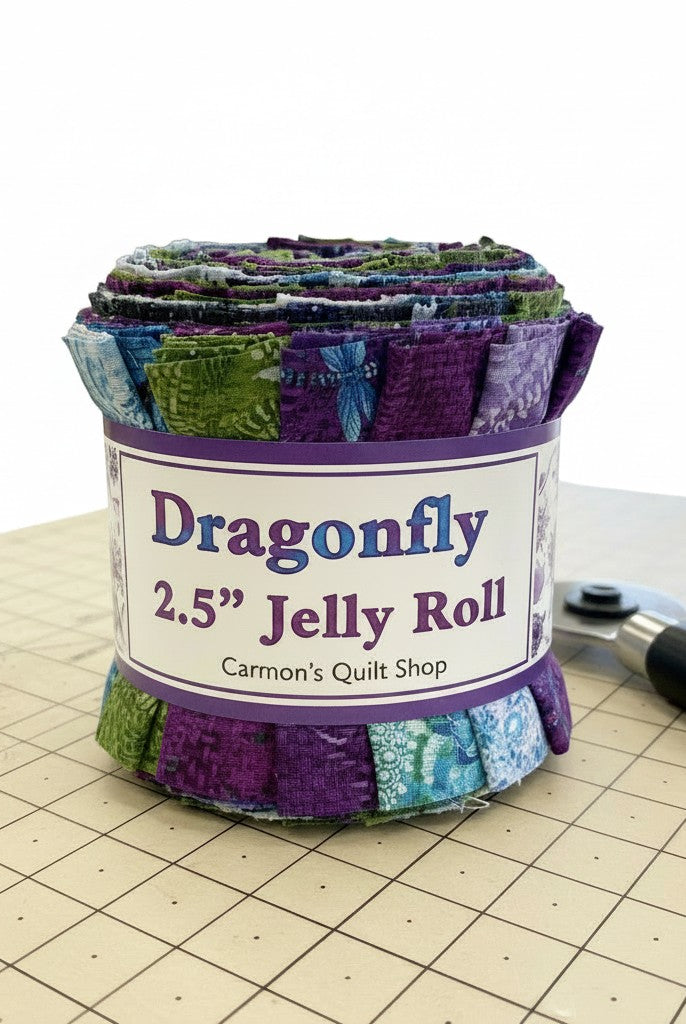 Carmon's Quilt Shop Dragonfly Wonder jelly roll featuring 40 pre-cut cotton fabric strips in purple and green tones.