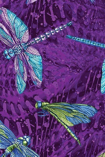 Carmon's Quilt Shop Dragonfly Wonder cotton fabric featuring vibrant blue and green dragonflies on a purple background