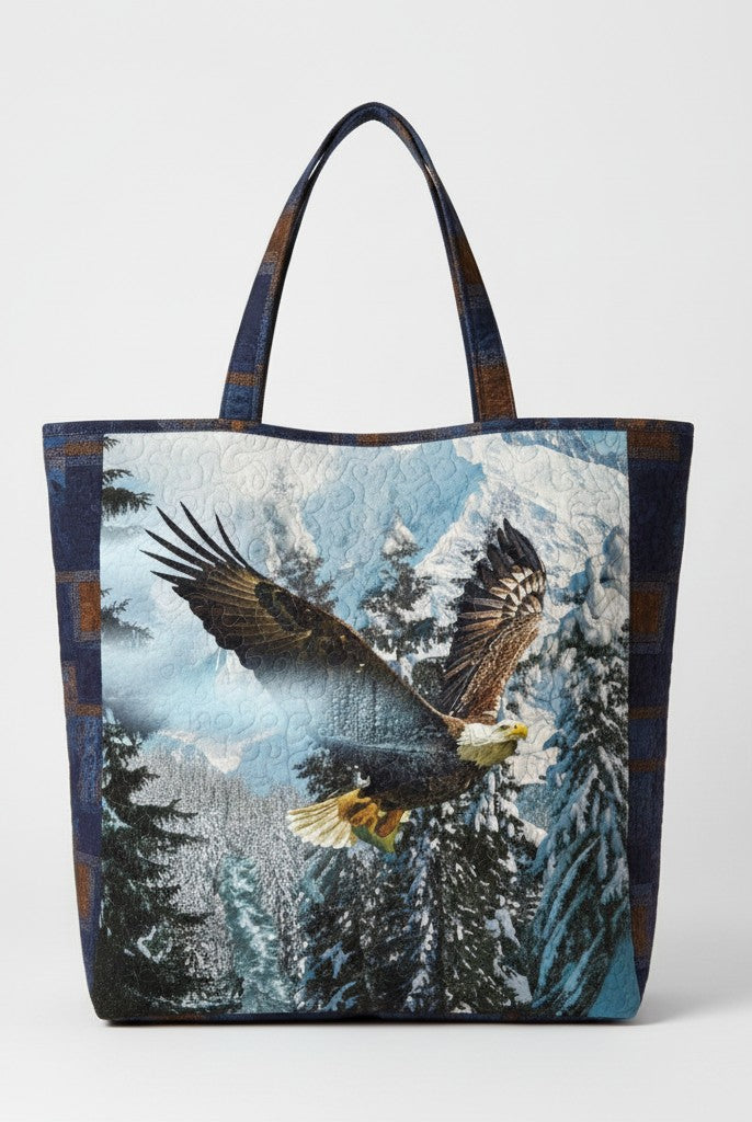 Carmon's Quilt Shop tote bag featuring a Hoffman Fabrics eagle mountain landscape print in blue, white, and brown.