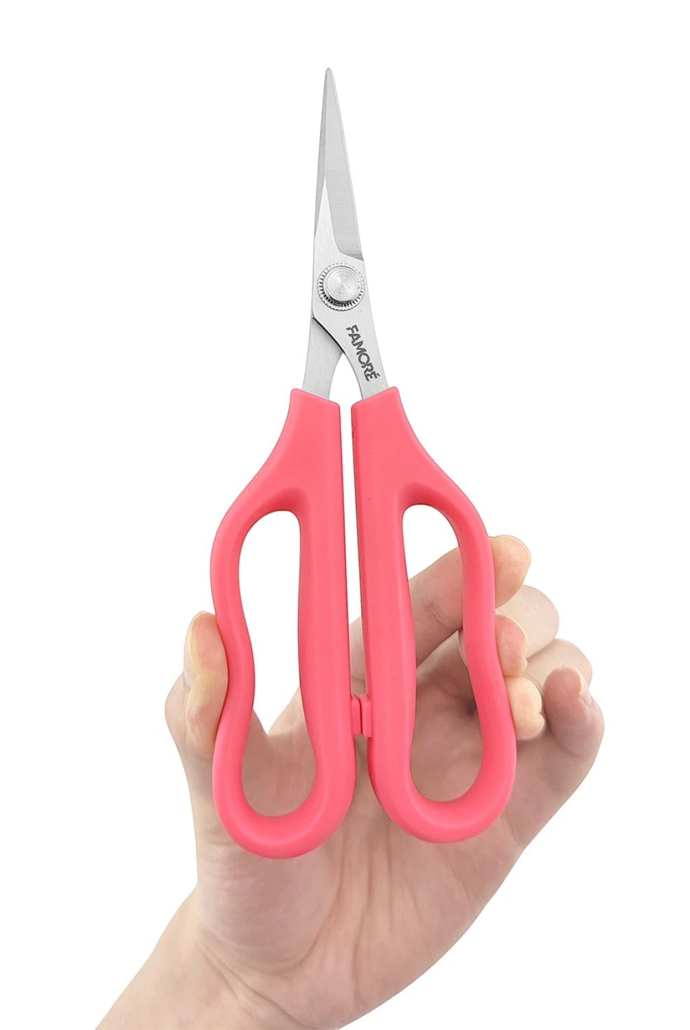 Carmon's Quilt Shop FAMORÉ 6.25-inch precision crafting scissors with pink ergonomic handles held in a hand