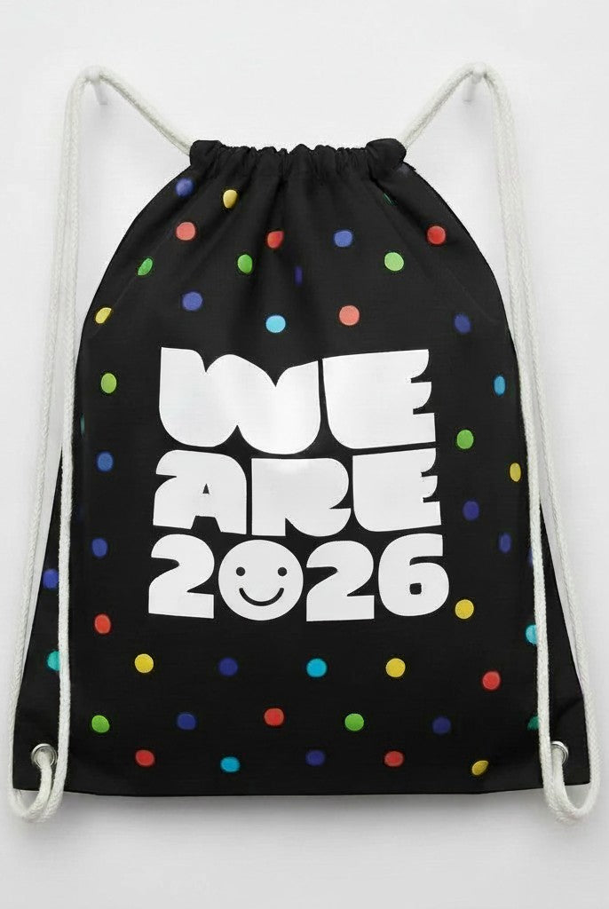 Carmon's Quilt Shop black drawstring backpack with colorful polka dots and "WE ARE 2026" text.