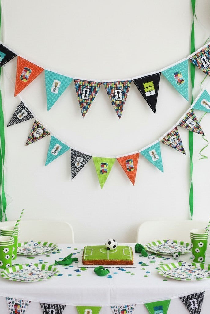 Carmon's Quilt Shop FIFA World Cup 2026 bunting kit with colorful pennants, football graphics, and green streamers.