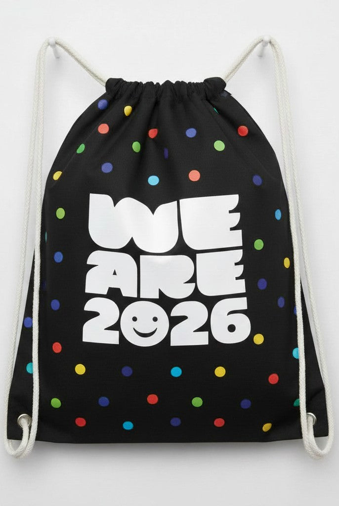 Carmon's Quilt Shop black drawstring backpack with colorful polka dots and "WE ARE 2026" text.