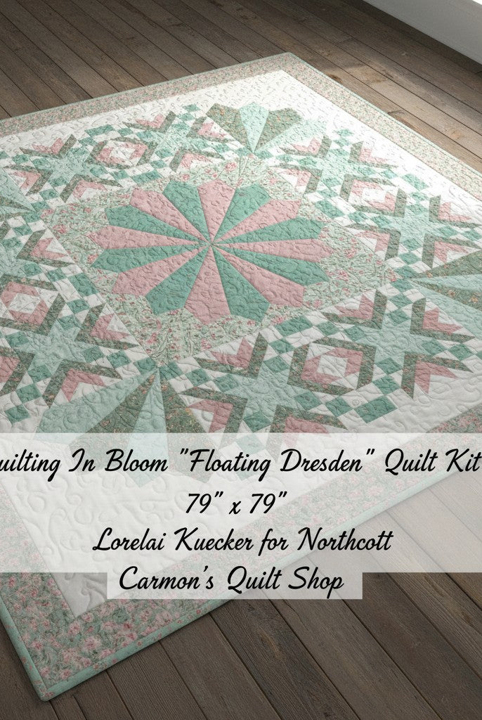 Carmon's Quilt Shop Floating Dresden quilt kit in floral cotton fabrics with pink and green tones on wood floor.