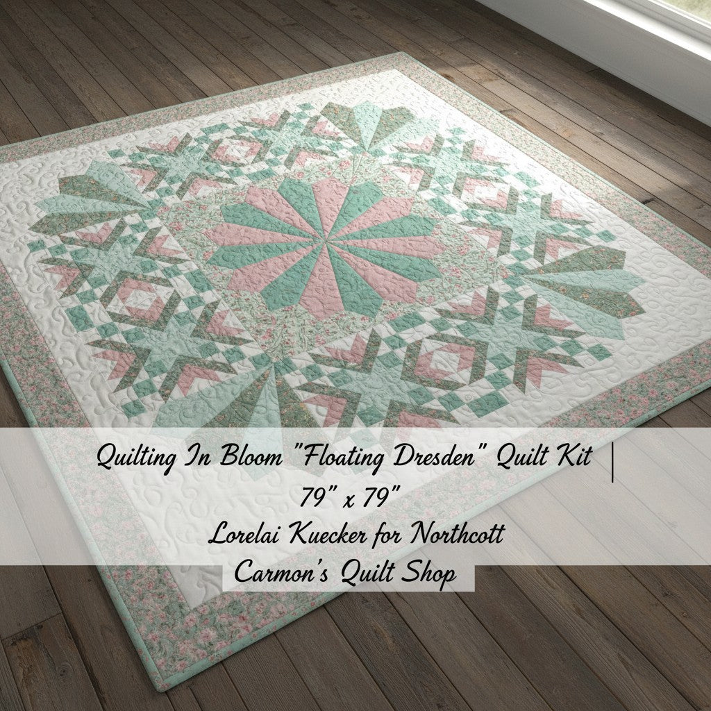 Carmon's Quilt Shop Floating Dresden quilt kit in floral cotton fabrics with pink and green tones on wood floor.