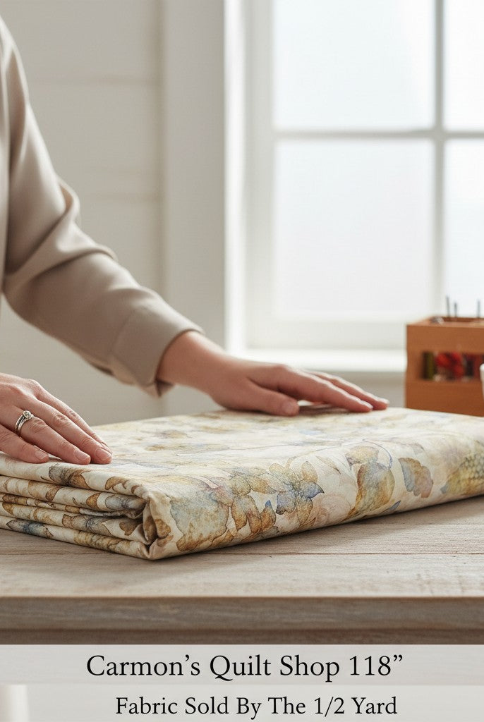 Carmon's Quilt Shop 118 inch wide cotton fabric with tonal floral print folded on a wooden table