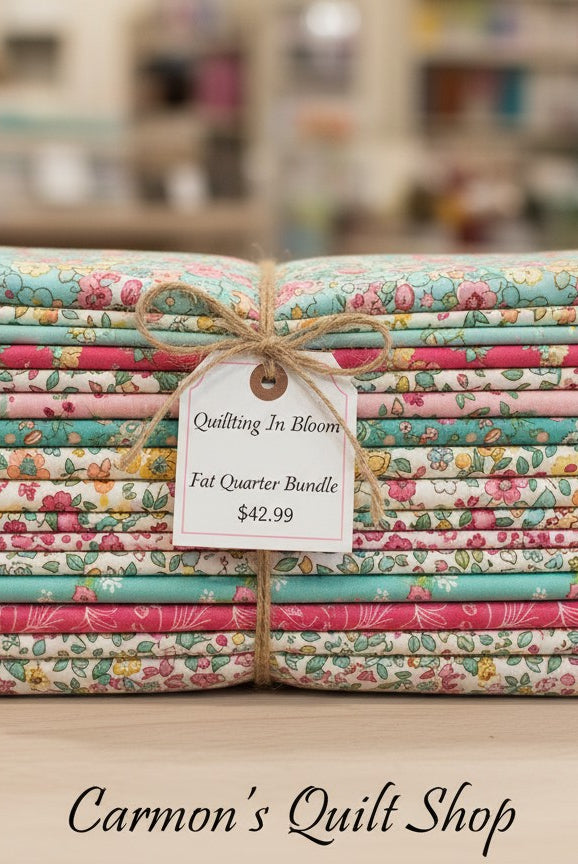 Carmon's Quilt Shop Quilting in Bloom 13-piece floral cotton fat quarter bundle tied with twine and a price tag.