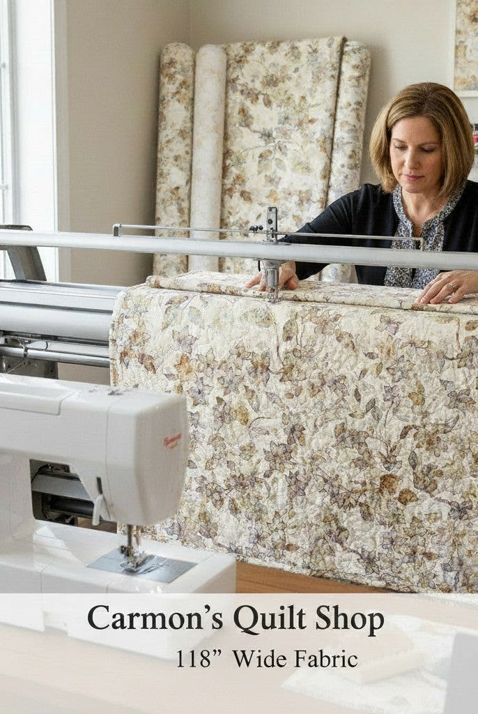 Carmon's Quilt Shop woman using a longarm quilting machine with QT Fabrics Panorama tonal floral 118 inch cotton fabric
