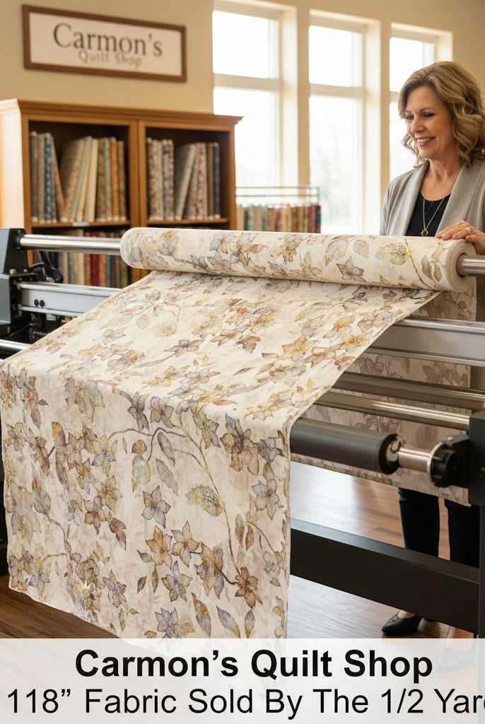 Carmon's Quilt Shop woman using a longarm machine with QT Fabrics Panorama tonal floral 118 inch wide cotton backing