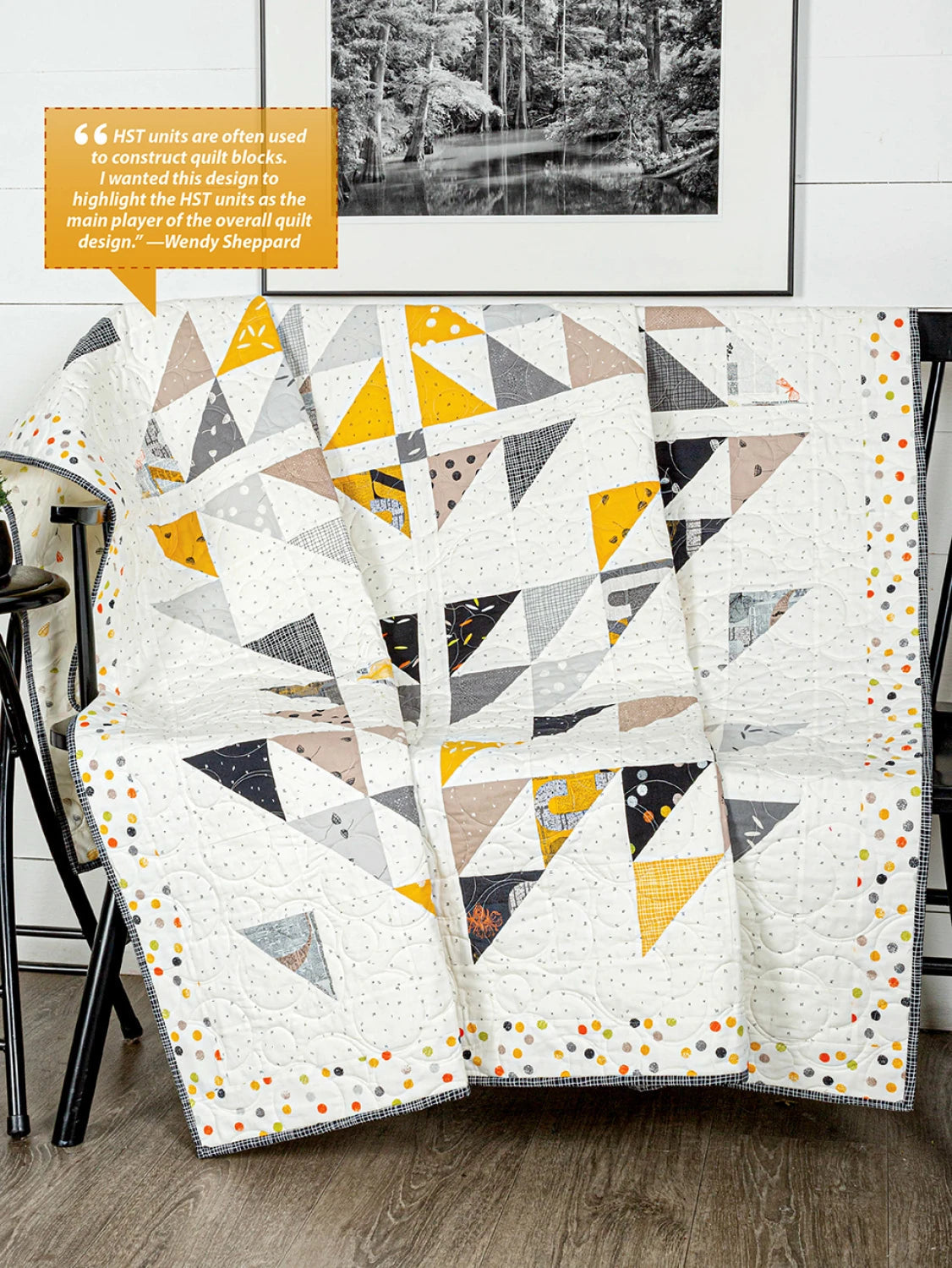 Carmon's Quilt Shop Fun With Squares quilt featuring geometric triangle patterns in yellow, grey, and white fabric.