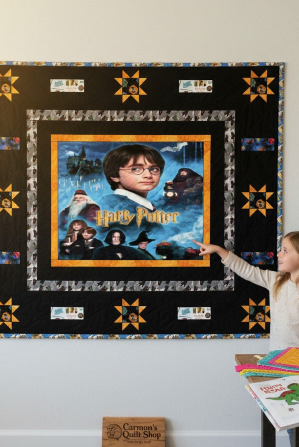 Carmon's Quilt Shop Harry Potter themed quilt pattern featuring characters and Hogwarts castle. Black border with star accents.