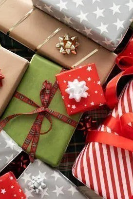 Carmon's Quilt Shop advent box collection featuring festive wrapped gifts with red, green, and silver holiday patterns