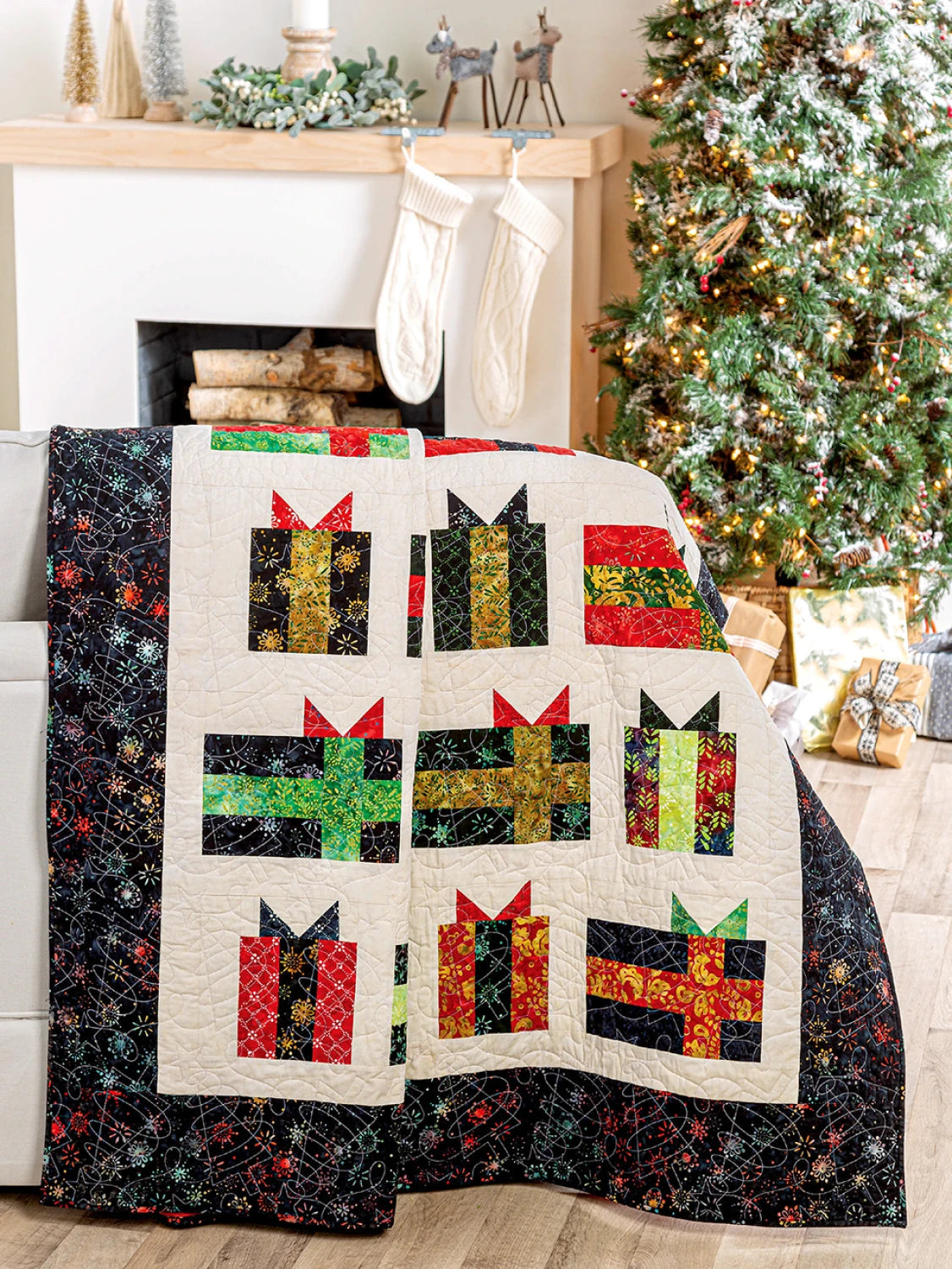Carmon's Quilt Shop Jelly Roll quilt featuring colorful gift box patterns on a cream background with a black border