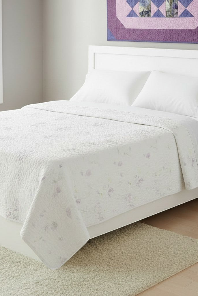 Carmon's Quilt Shop Lovely Flowers quilt pattern featuring soft floral prints on a white bed in a bright bedroom.