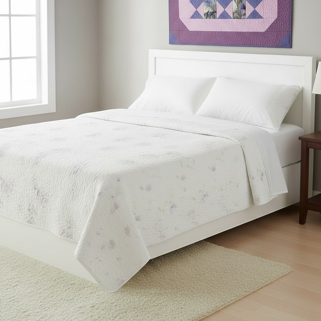 Carmon's Quilt Shop Lovely Flowers quilt pattern featuring soft floral prints on a white bed in a bright bedroom.