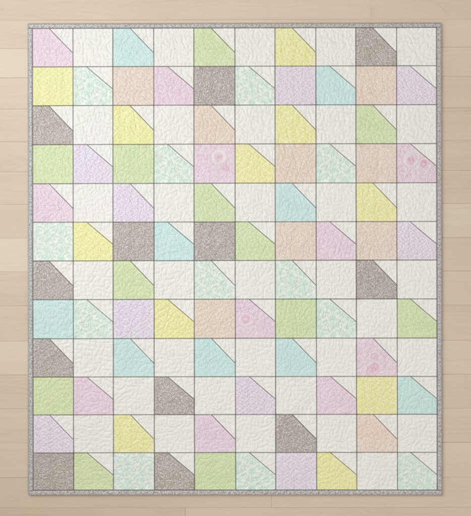 Carmon's Quilt Shop Main Street quilt kit featuring colorful geometric patchwork in soft pastel fabric prints.