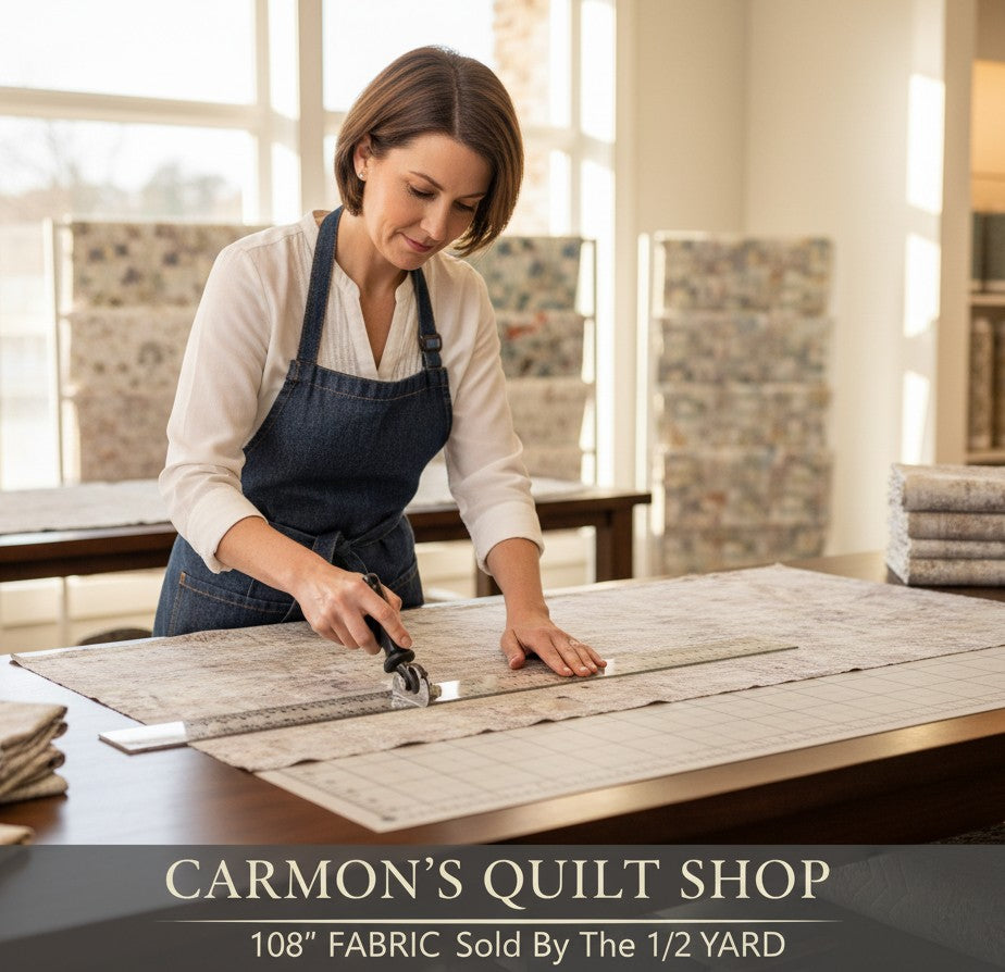 Carmon's Quilt Shop artisan cutting mottled gray 108-inch wide QT Fabrics quilting cotton on a cutting mat.
