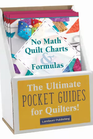 Carmon's Quilt Shop display box containing No Math Quilt Charts & Formulas pocket guides for quilting reference