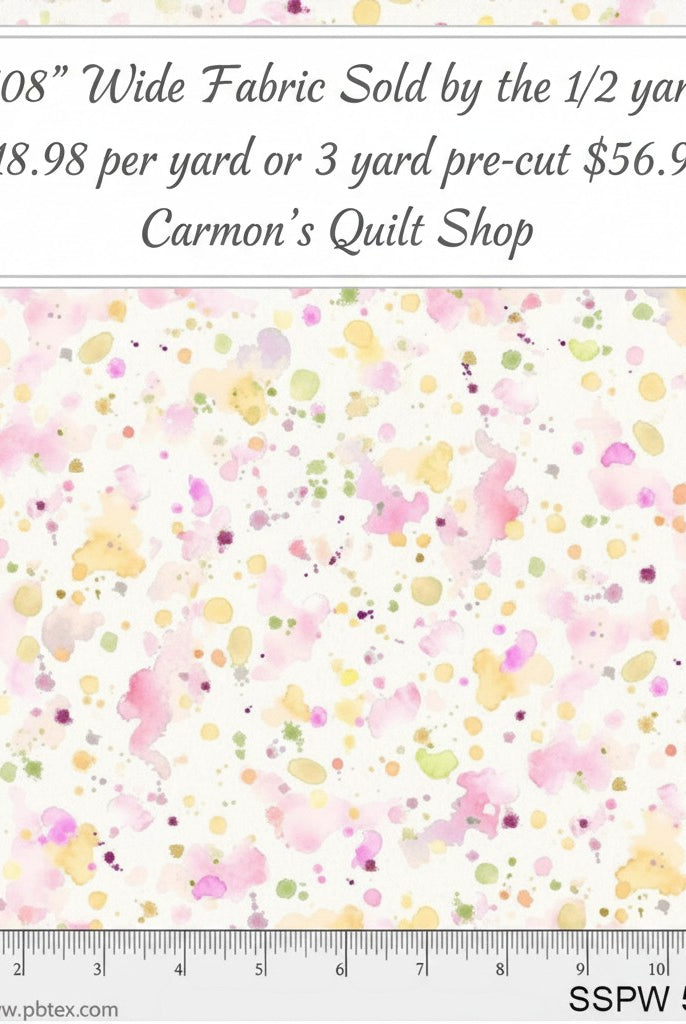 Carmon's Quilt Shop 108 inch wide cotton backing fabric featuring a colorful pink, yellow, and green paint splatter design.