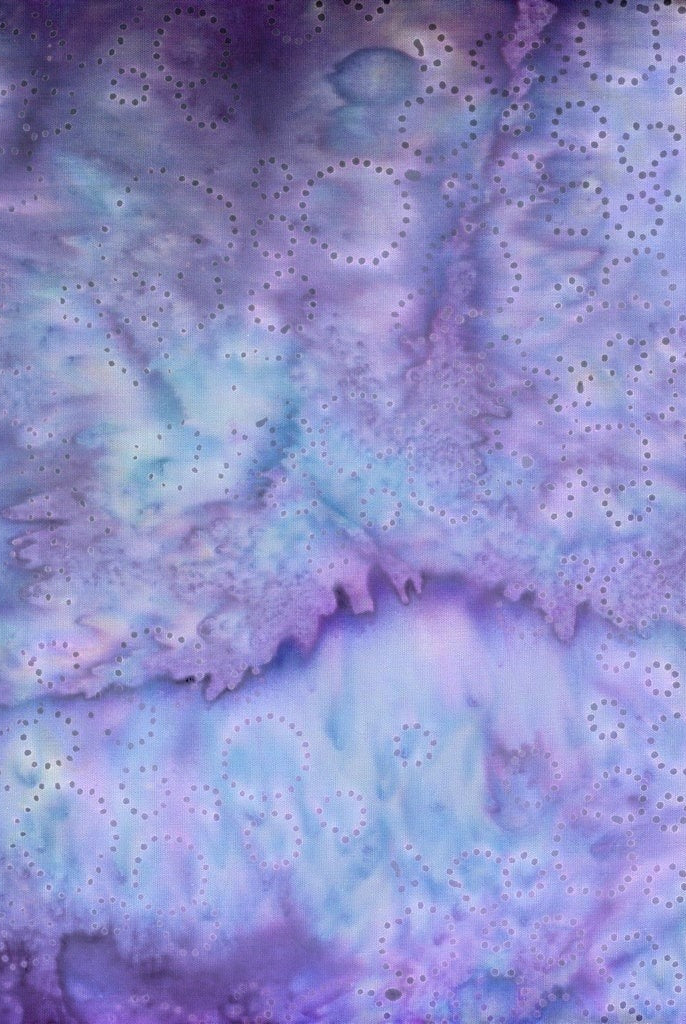 Carmon's Quilt Shop Vintner's Treasure purple and green batik cotton fabric with a delicate circular dot pattern.