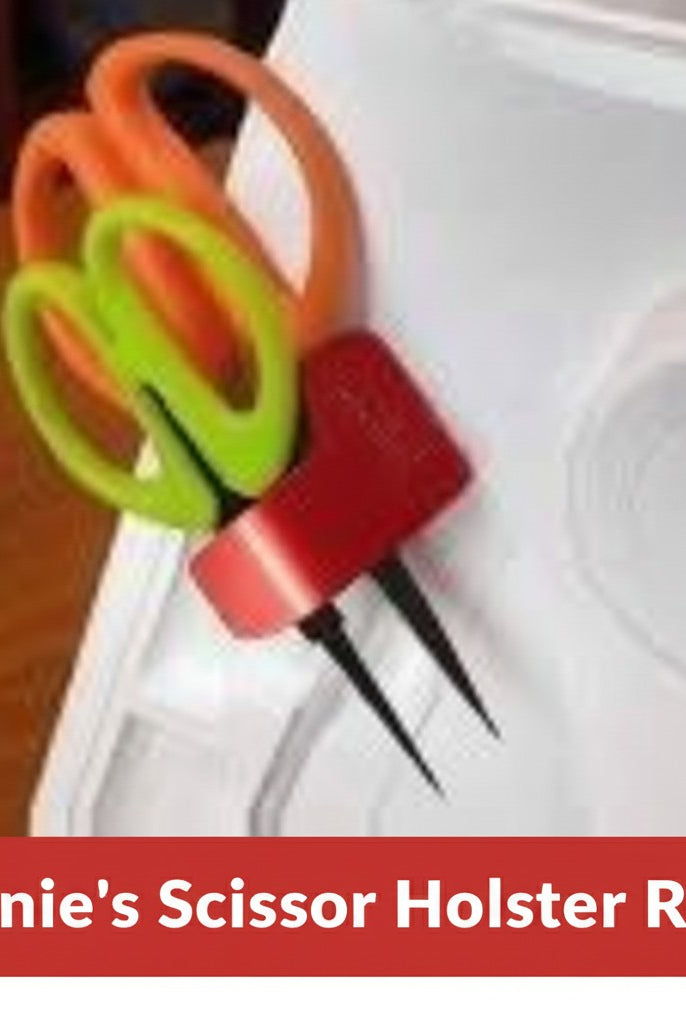 Carmon's Quilt Shop red Sew Very Smooth scissor holster with two slots holding scissors on a sewing machine