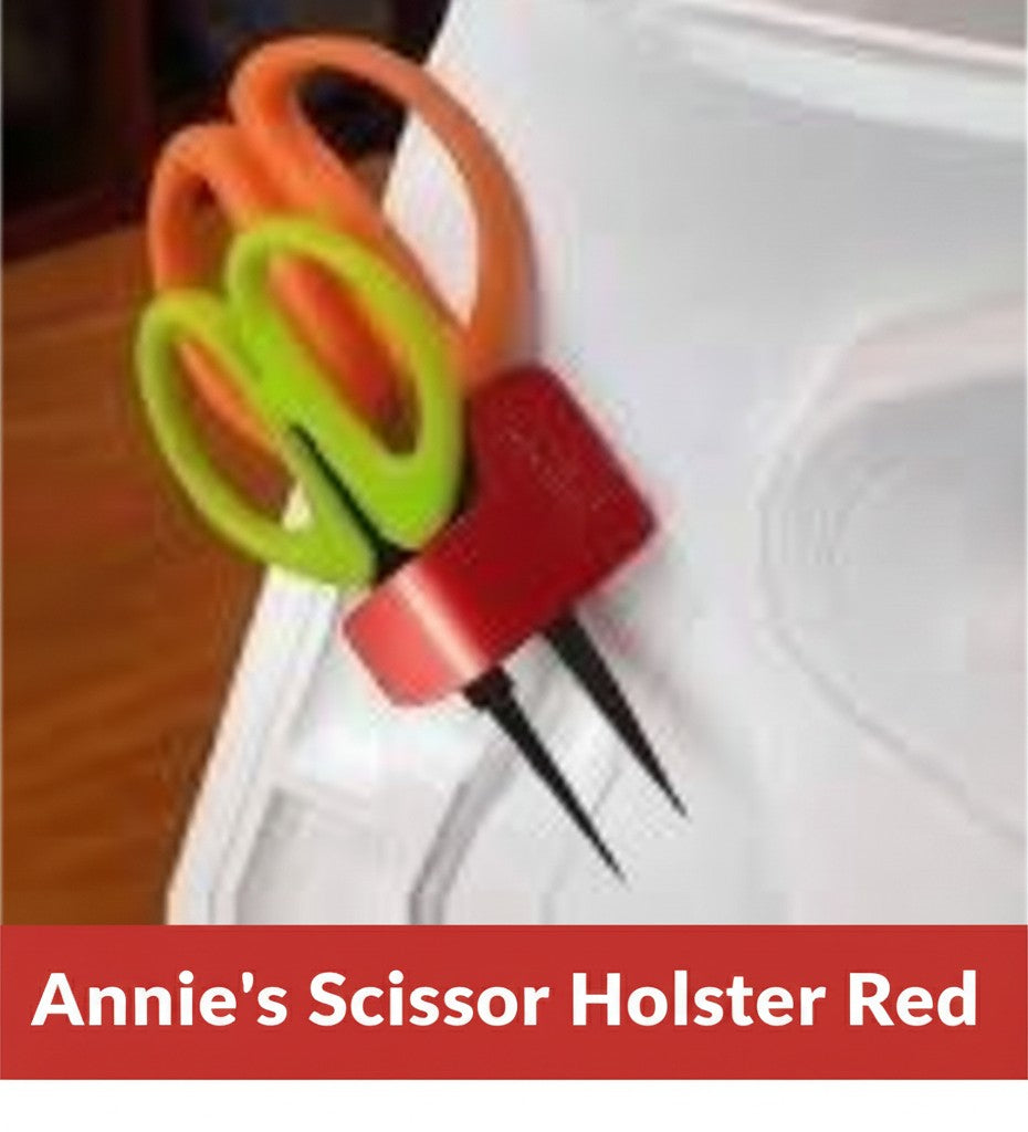 Carmon's Quilt Shop red Sew Very Smooth scissor holster with two slots holding scissors on a sewing machine