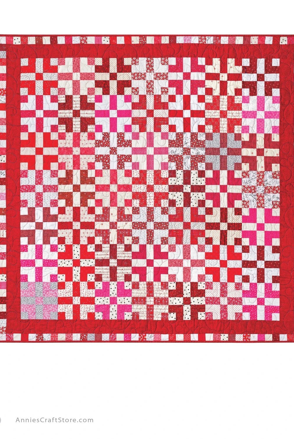 Carmon's Quilt Shop two-color red and white quilt featuring a geometric block pattern with a decorative border