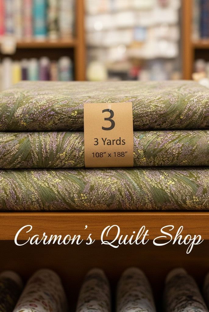 Carmon's Quilt Shop Meadow Breeze sage green floral 108-inch wide cotton quilt backing fabric folded on a shelf