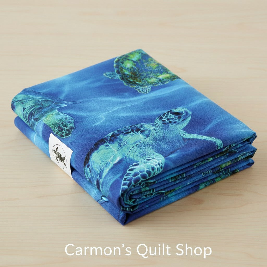 Carmon's Quilt Shop 108-inch wide blue cotton quilting fabric featuring a detailed sea turtle underwater print.