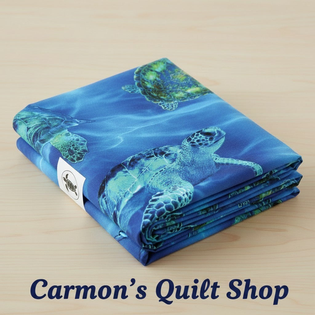 Carmon's Quilt Shop 108-inch wide cotton quilting fabric featuring a vibrant blue sea turtle underwater print.