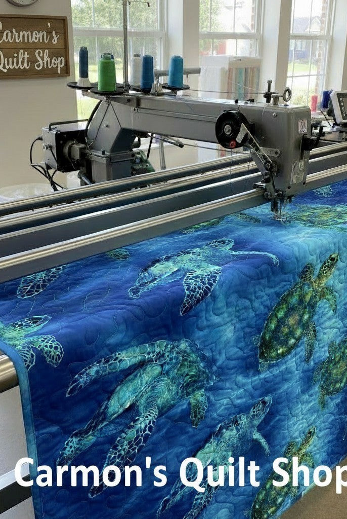 Carmon's Quilt Shop sea turtle patterned 108-inch cotton quilting fabric on a longarm quilting machine